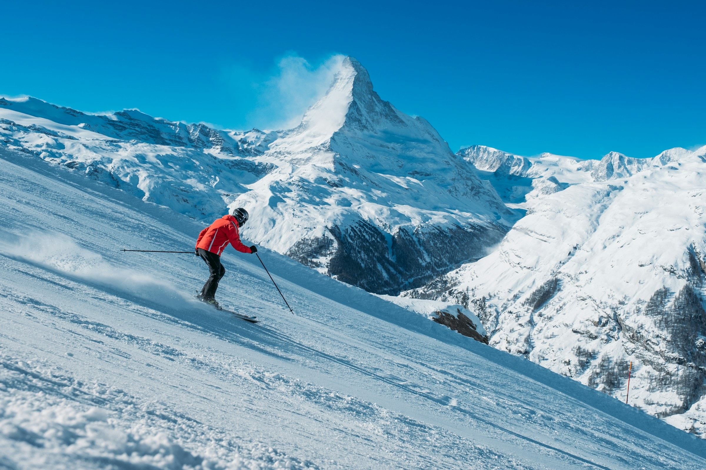 Skier carving down a snowy slope